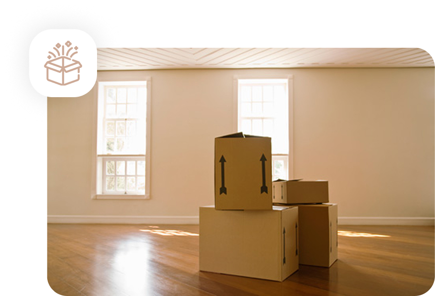 Cardboard moving boxes stacked in an empty, clean room with hardwood floors and sunlight coming through the windows, symbolizing a move-in/move-out cleaning.